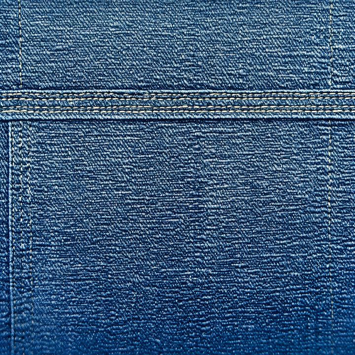 Cracked Denim Fabric with Detailed Stitching in Blue seamless PBR texture preview