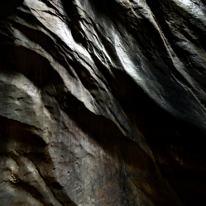 Dark Sculpted Stone with Natural Depths and Shadows seamless PBR texture preview